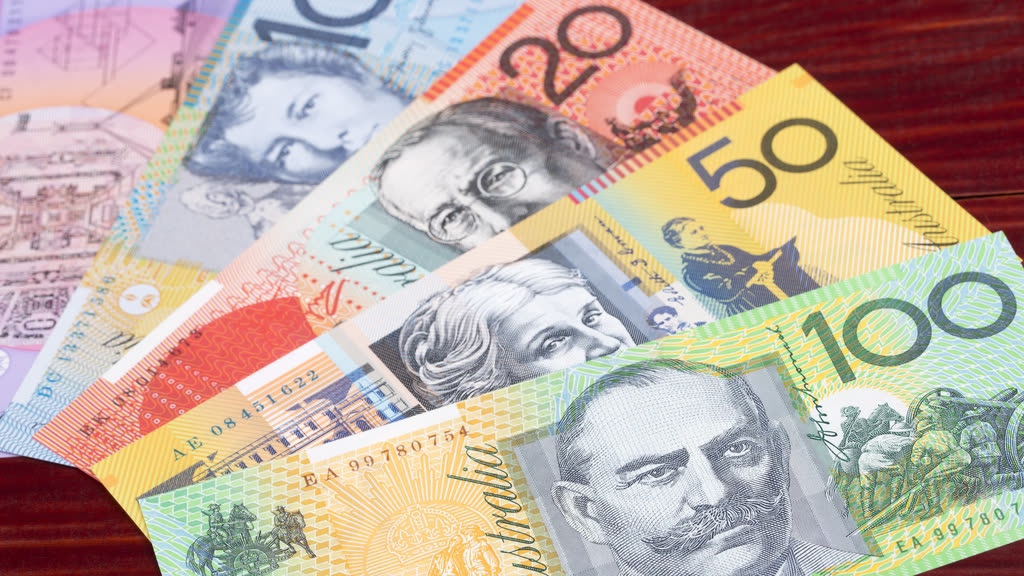 Australian banknotes fanned out on a wooden table