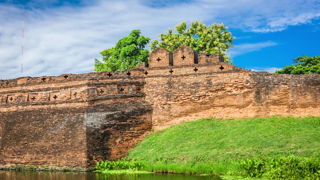 The old city wall and moat in Chiang Mai on a sunny day