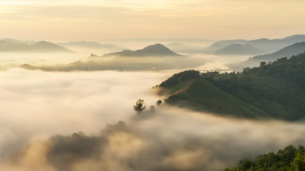 Morning fog filling the valleys below forested hills at Phu Pha Duk, Nong Khai, in northeastern Thailand