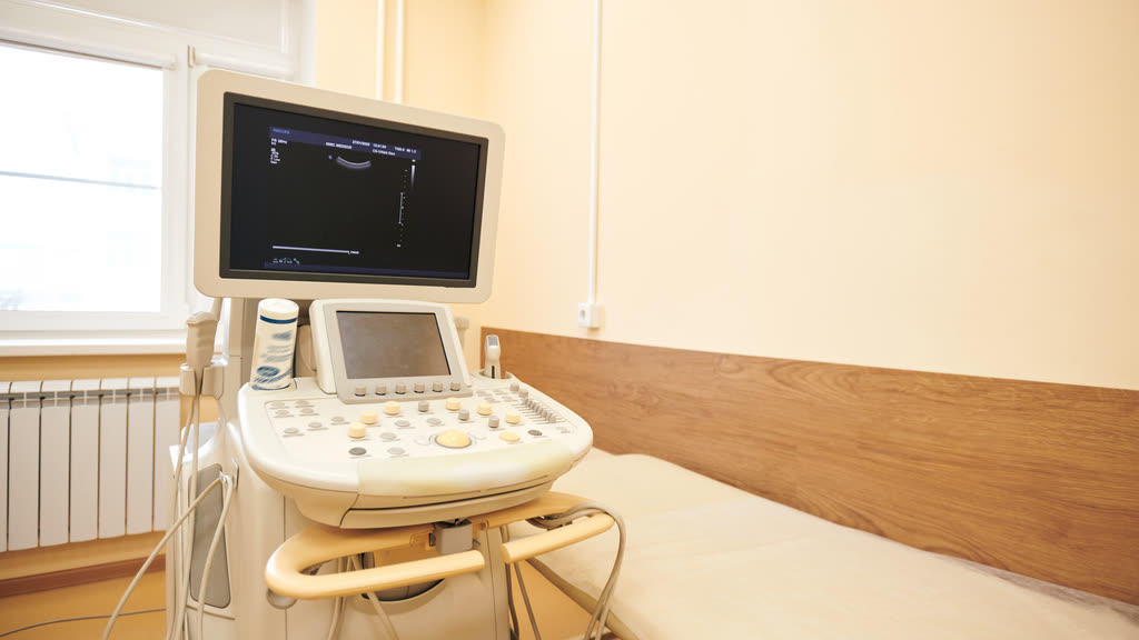 An ultrasound machine in an empty clinic room